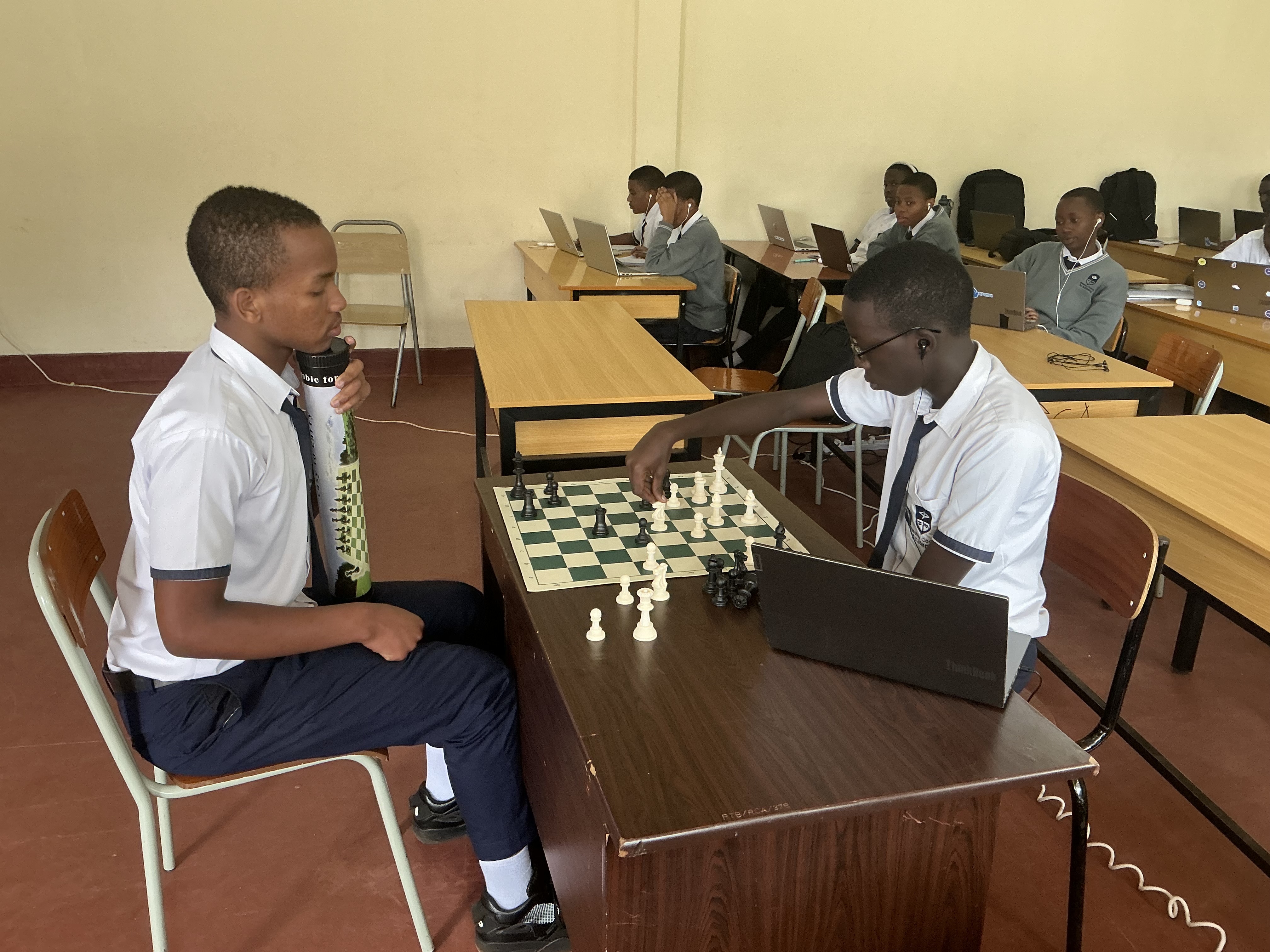 Students playing chess game